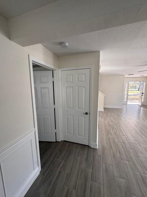 hall with a textured ceiling