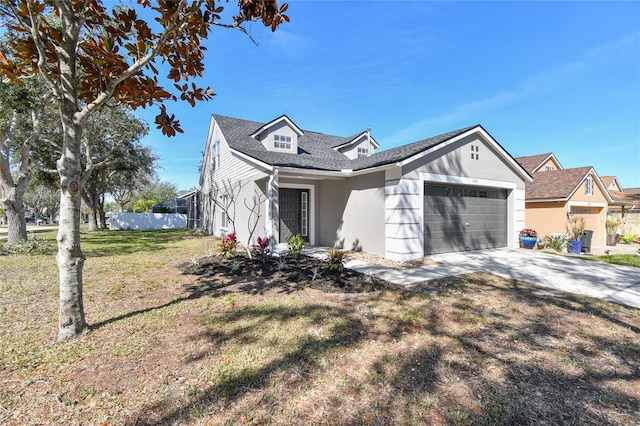 view of front of home with a front lawn, concrete driveway, and an attached garage