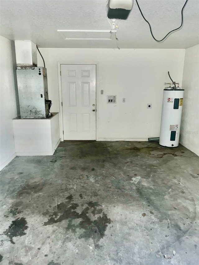 garage featuring water heater, heating unit, and a garage door opener