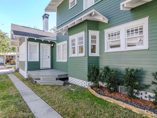 entrance to property with a lawn