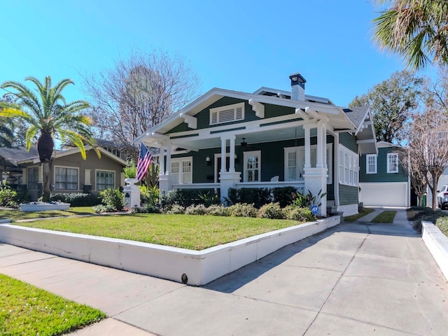 view of front of house with a garage and a front lawn