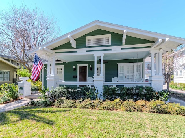 bungalow-style house featuring a porch and a front yard