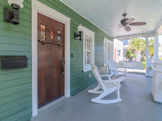 wooden deck with ceiling fan and covered porch