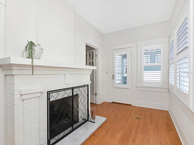 unfurnished living room with hardwood / wood-style flooring