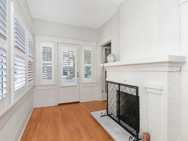 living room with hardwood / wood-style floors and a fireplace