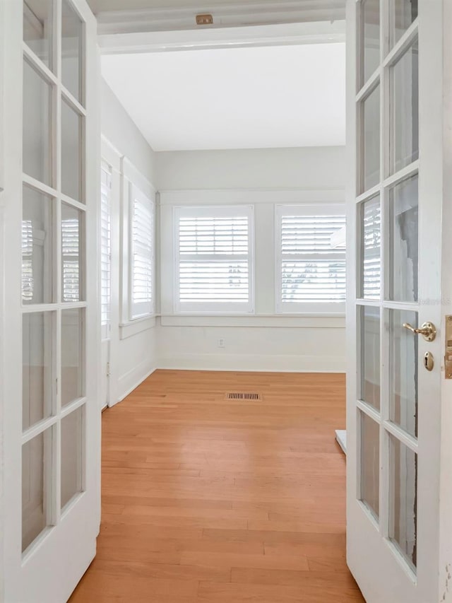 unfurnished sunroom featuring french doors