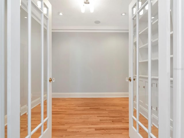 spacious closet with french doors and hardwood / wood-style floors