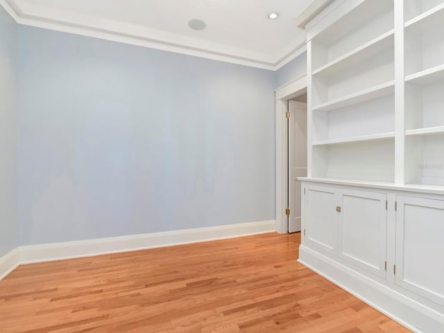 unfurnished room with crown molding and light hardwood / wood-style flooring