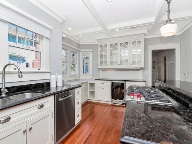 kitchen featuring sink, stainless steel appliances, wine cooler, white cabinets, and decorative light fixtures