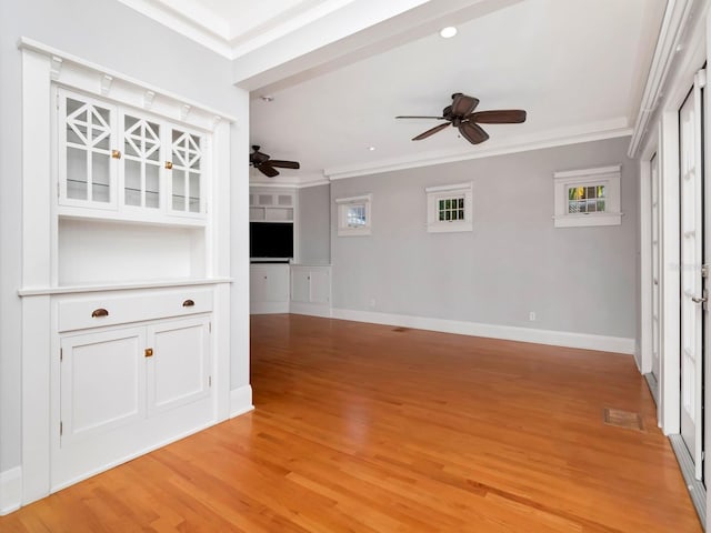 unfurnished living room featuring crown molding, ceiling fan, and light hardwood / wood-style floors