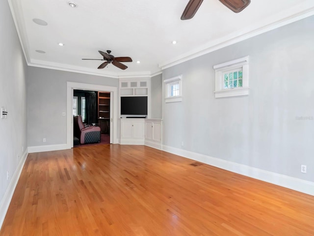 unfurnished living room with crown molding, light hardwood / wood-style floors, and ceiling fan