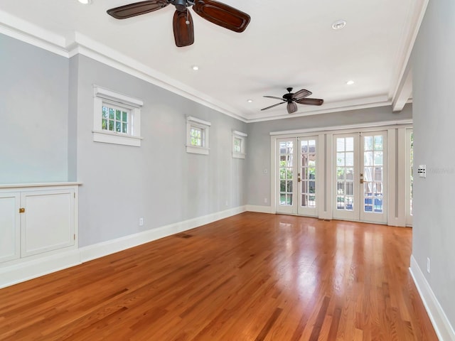 spare room with a wealth of natural light, ornamental molding, and french doors