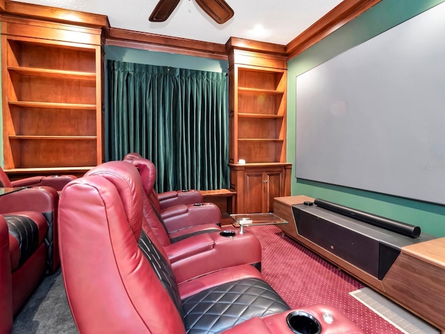 carpeted cinema room featuring ornamental molding and ceiling fan