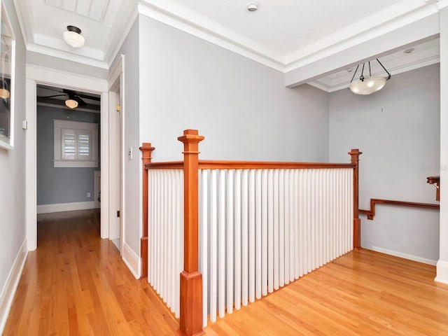 hallway with hardwood / wood-style floors and crown molding