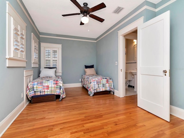 bedroom featuring light hardwood / wood-style flooring, ornamental molding, and ceiling fan