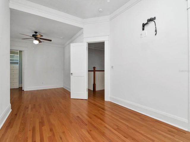 spare room featuring hardwood / wood-style flooring, ornamental molding, and ceiling fan