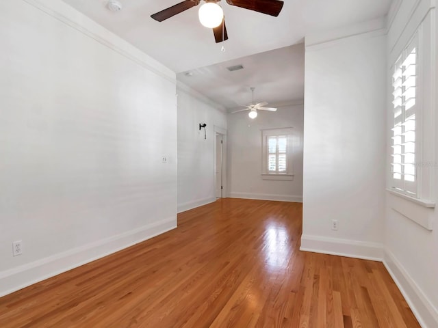 unfurnished room featuring ornamental molding, ceiling fan, and light hardwood / wood-style floors