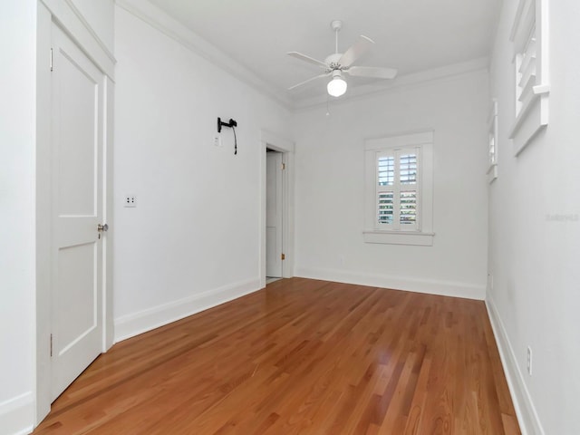 unfurnished room with hardwood / wood-style floors, ornamental molding, and ceiling fan