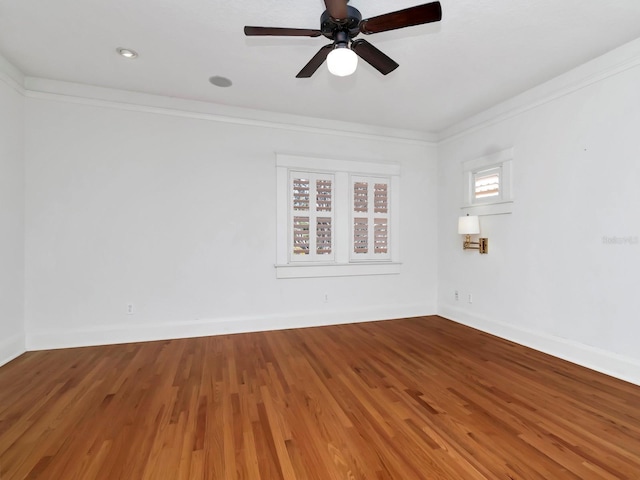 empty room featuring hardwood / wood-style flooring, ceiling fan, and ornamental molding