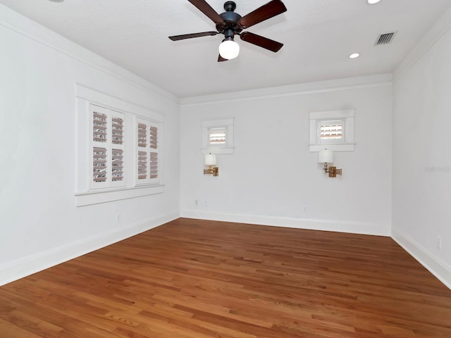 unfurnished room with crown molding, wood-type flooring, and ceiling fan