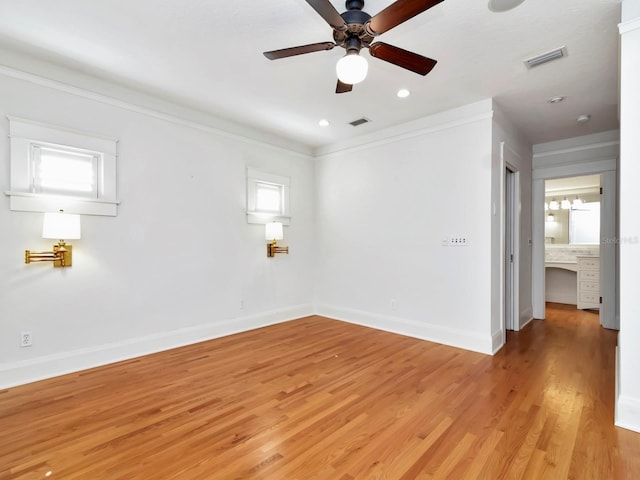 unfurnished room with ornamental molding, light hardwood / wood-style floors, and ceiling fan