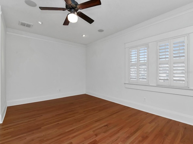 empty room featuring crown molding, ceiling fan, and hardwood / wood-style floors