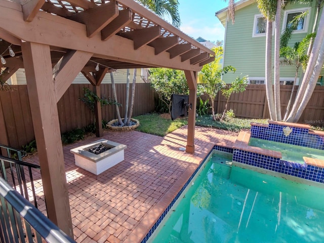 view of patio with a fenced in pool, pool water feature, and an outdoor fire pit