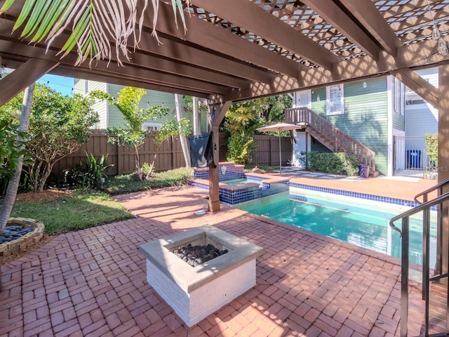 view of pool with an in ground hot tub, a pergola, a patio area, and a fire pit