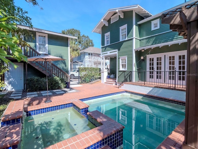 view of swimming pool featuring an in ground hot tub