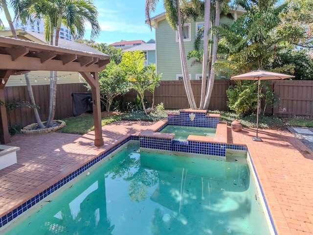 view of swimming pool featuring an in ground hot tub and a patio area