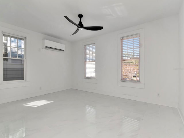 spare room featuring a wall unit AC and ceiling fan