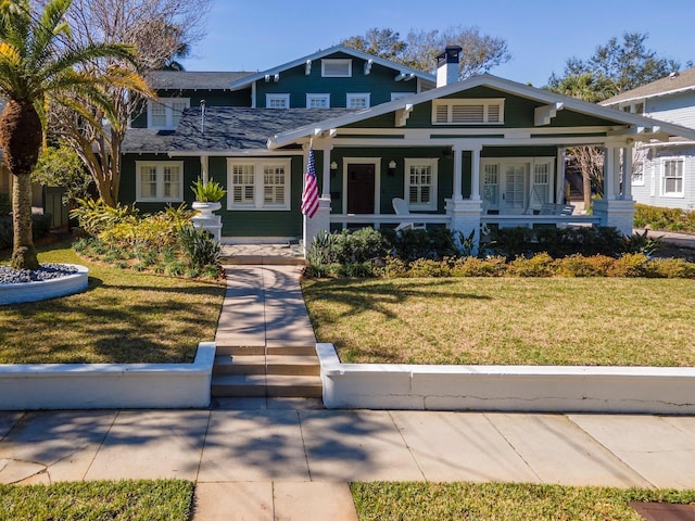 craftsman house with covered porch and a front yard