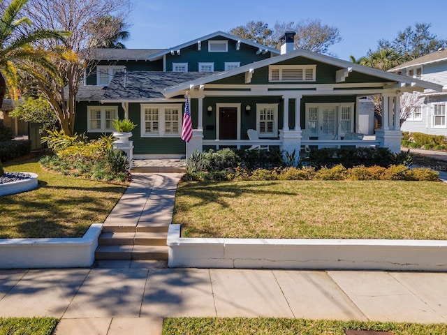 craftsman-style house featuring a front lawn and a porch