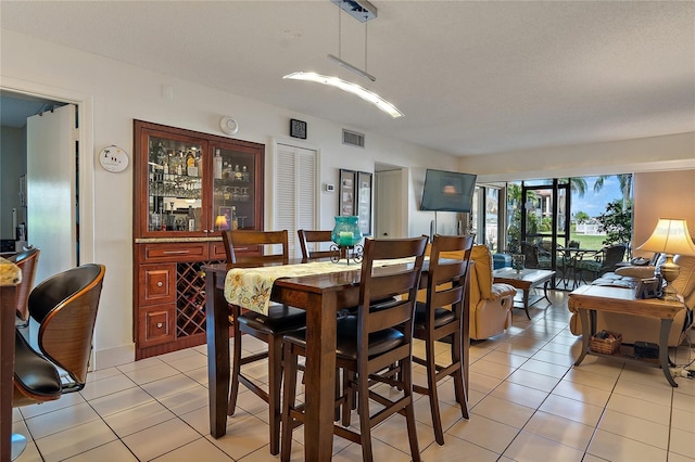 dining space featuring light tile patterned flooring