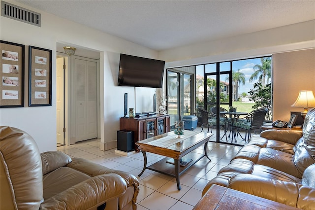 living room with light tile patterned floors and a textured ceiling