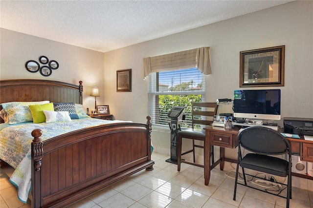 bedroom with light tile patterned floors and a textured ceiling