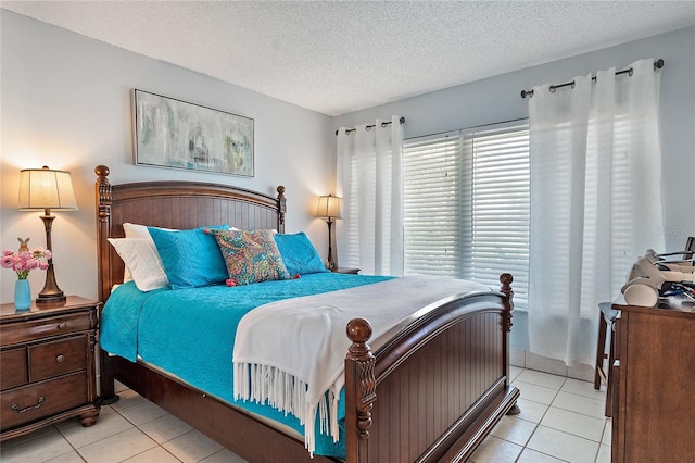 tiled bedroom featuring a textured ceiling