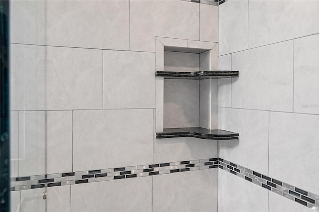 interior details featuring a shower