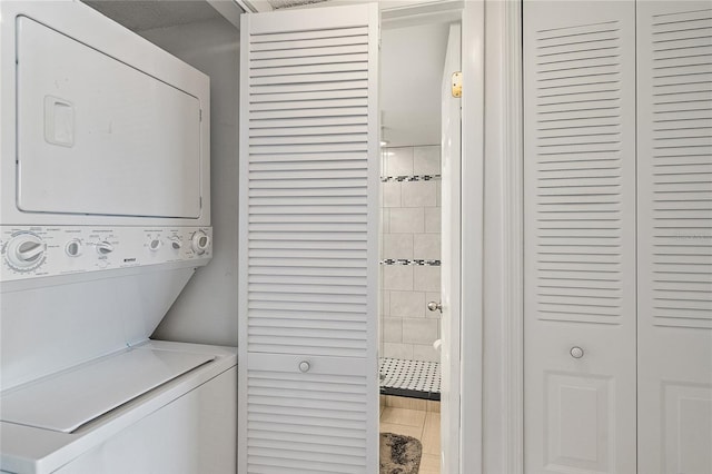 clothes washing area featuring stacked washer / drying machine