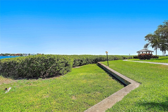 view of yard featuring a gazebo and a water view