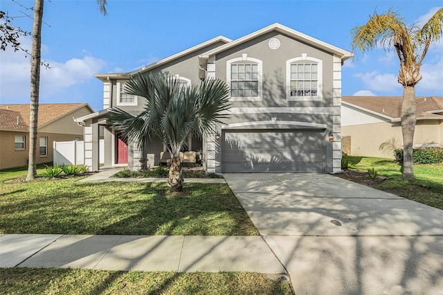 view of front of property with a garage and a front lawn