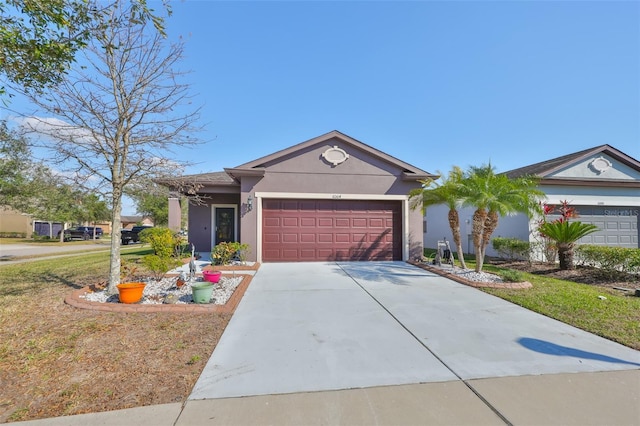 ranch-style house with a garage and a front yard