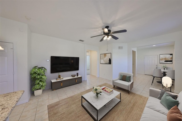 living room with ceiling fan and light tile patterned floors