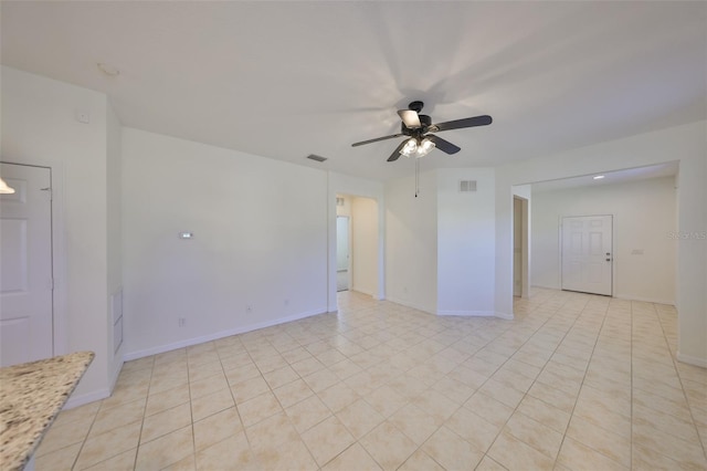 spare room with light tile patterned floors and ceiling fan