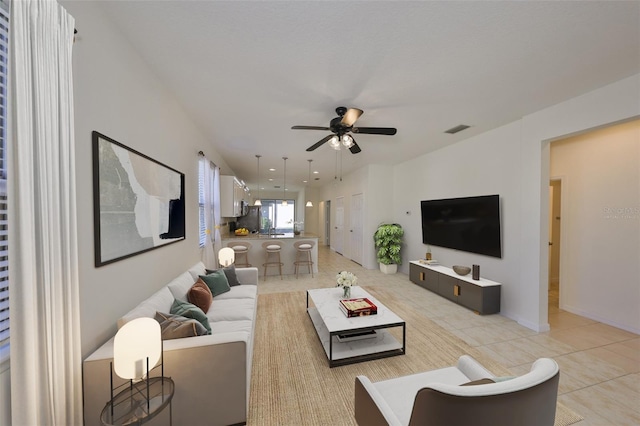 living room featuring ceiling fan and light tile patterned floors