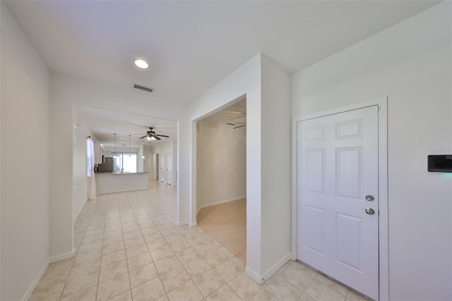 hall featuring light tile patterned floors