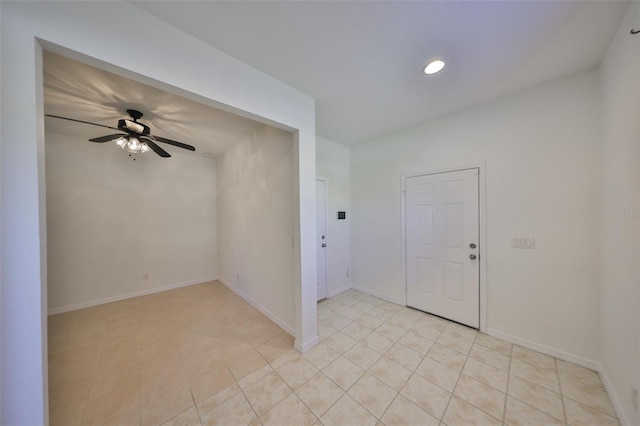 foyer with light tile patterned floors and ceiling fan