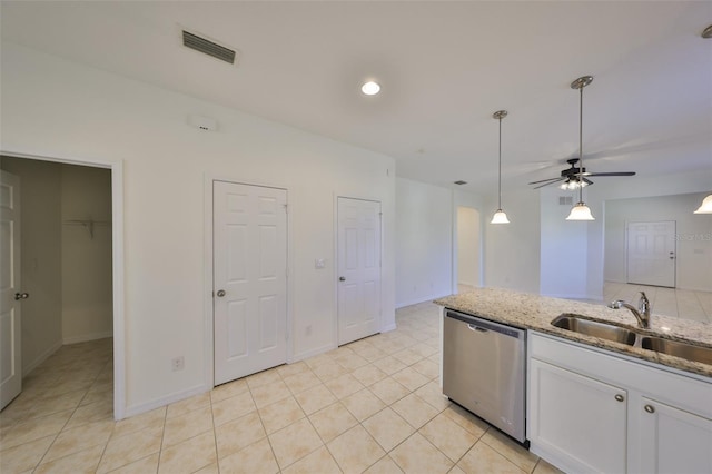 kitchen featuring sink, stainless steel dishwasher, pendant lighting, light stone countertops, and white cabinets