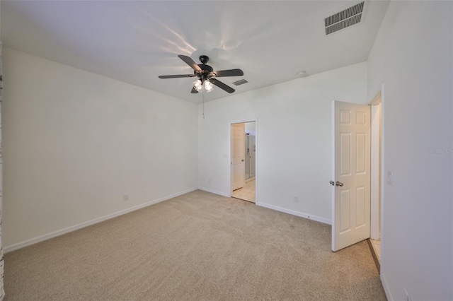 unfurnished bedroom with ceiling fan, ensuite bathroom, and light carpet