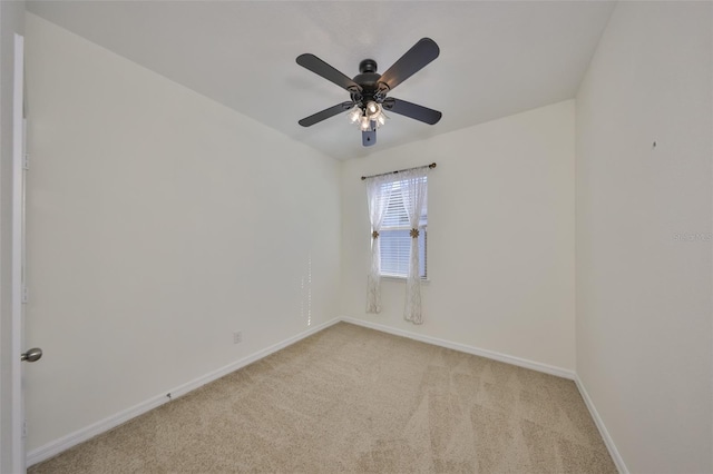 unfurnished room with ceiling fan and light carpet